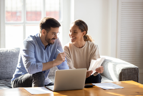 couple applying for an online loan at home from their laptop
